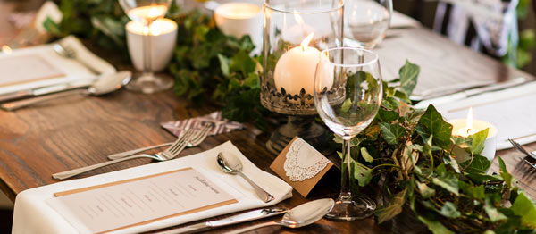 elegantly set dining table with candles