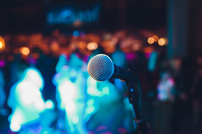 microphone in focus with blurred lively crowd background